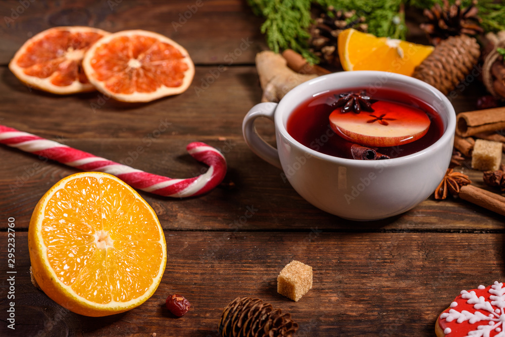 Christmas hot mulled wine with cinnamon cardamom and anise on wooden background Christmas hot mulled wine with cinnamon cardamom and anise on wooden background