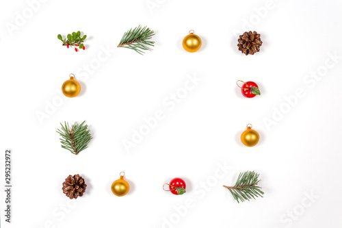 Creative flat lay of winter toys  berries  balls and cones on white background. Flat lay  top view. Holidays collection.