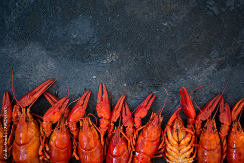 Red boiled crawfishes on table in rustic style, closeup. Lobster closeup.