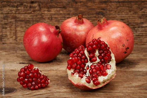 ripe pomegranate fruits on wooden table.