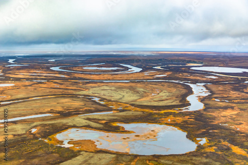 Wallpaper Mural Photographing from a helicopter in the Arctic. Autumn nature landscape of the northern tundra. The landscape of many lakes, rivers, variegated mosses and lichens. Gloomy autumn sky. Torontodigital.ca