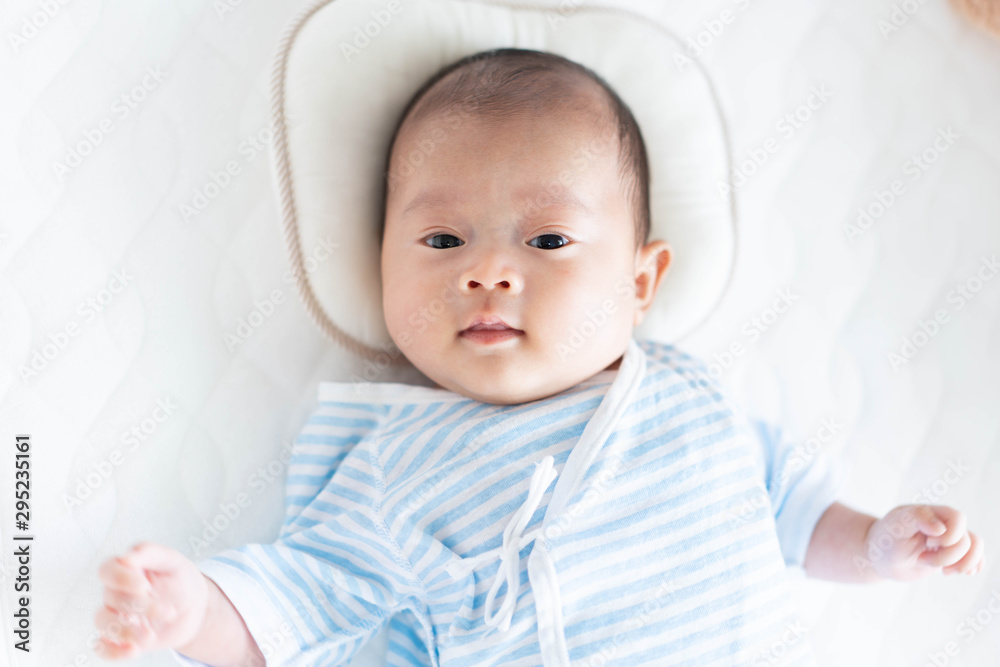 Baby lying on a crib Baby lying on a crib