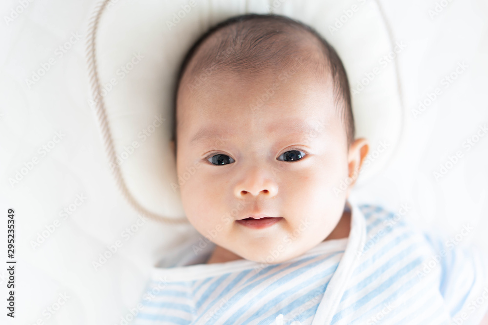 Baby lying on a crib