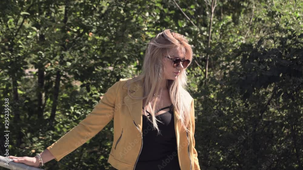 Pretty blonde in sunglasses and a yellow jacket Pretty blonde in sunglasses and a yellow jacket