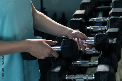 Women using dumbbell in gym