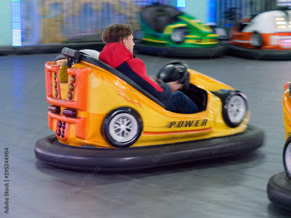 children ride a children's amusement ride electric cars