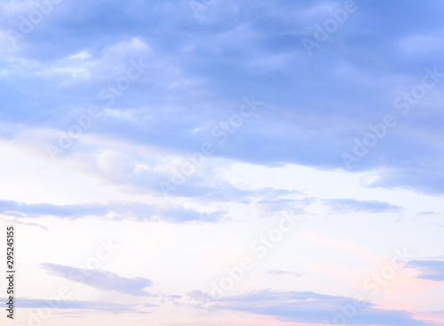 Beautiful pastel colored clouds at sunset isolated against blue skies