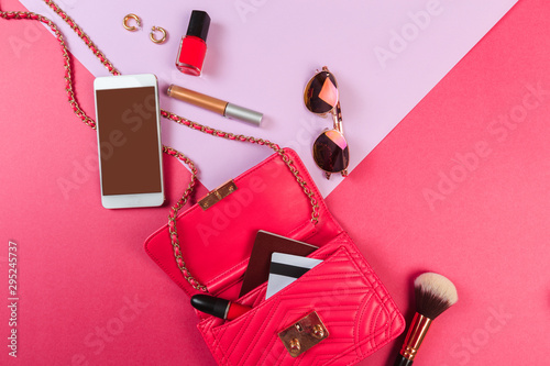 Top view of Women bag and lady stuff with copyspace on colour background- Image