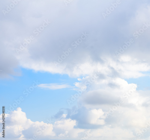 Beautiful puffy clouds with sun beams against blue skies. 