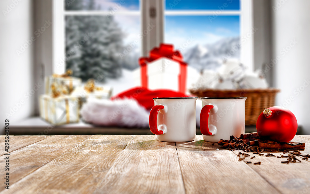 Fototapeta premium Christmas decorations in bright colors with blurred snowy winter outside the window background.