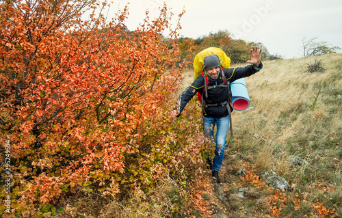 Hiker with a backpack walks high in the mountain in a autumn. Crimea