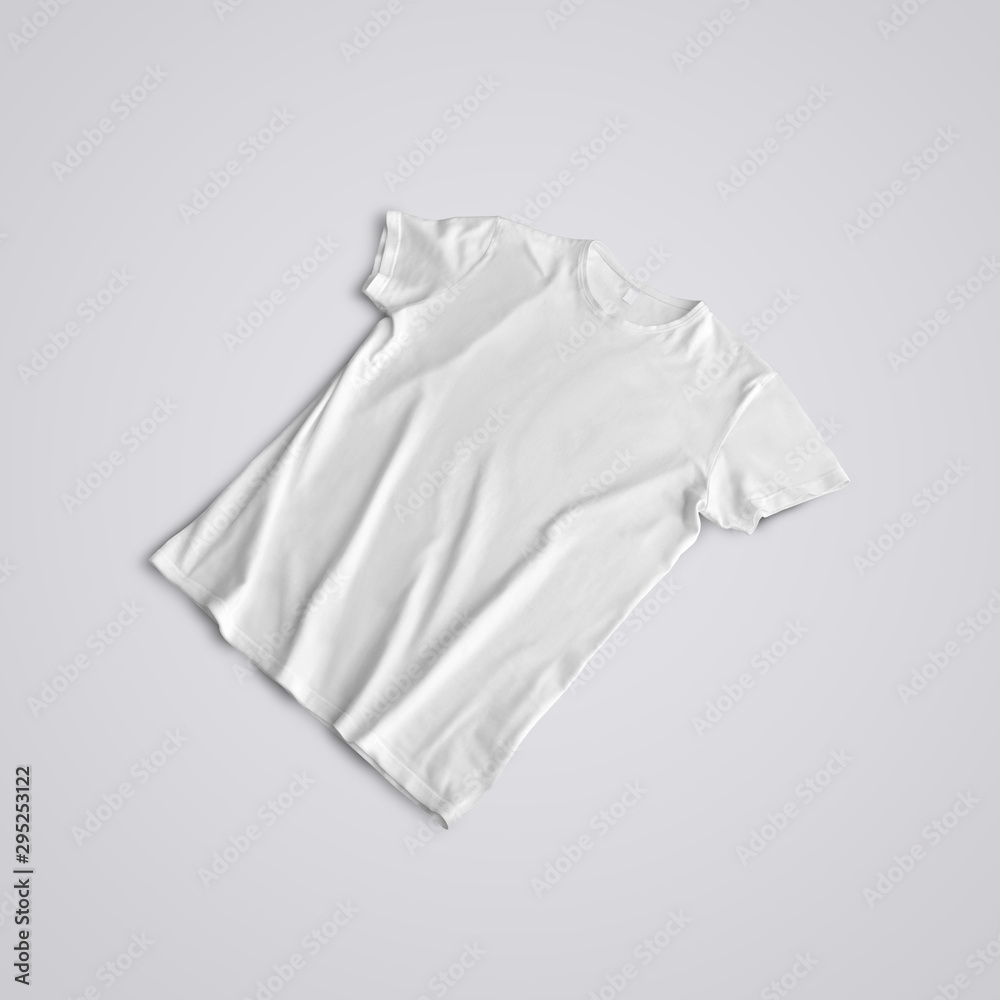 Unfolded blank T-shirt with shadows lying on the studio background. Unfolded blank T-shirt with shadows lying on the studio background.