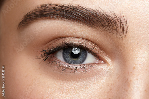 girl with nude make-up with blue eyes closeup
