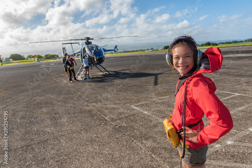 Helicopter tour Asian tourist walking on airport tarmac going to tourism excursion summer travel vacation leisure activity. Woman looking at camera excited candid. photo