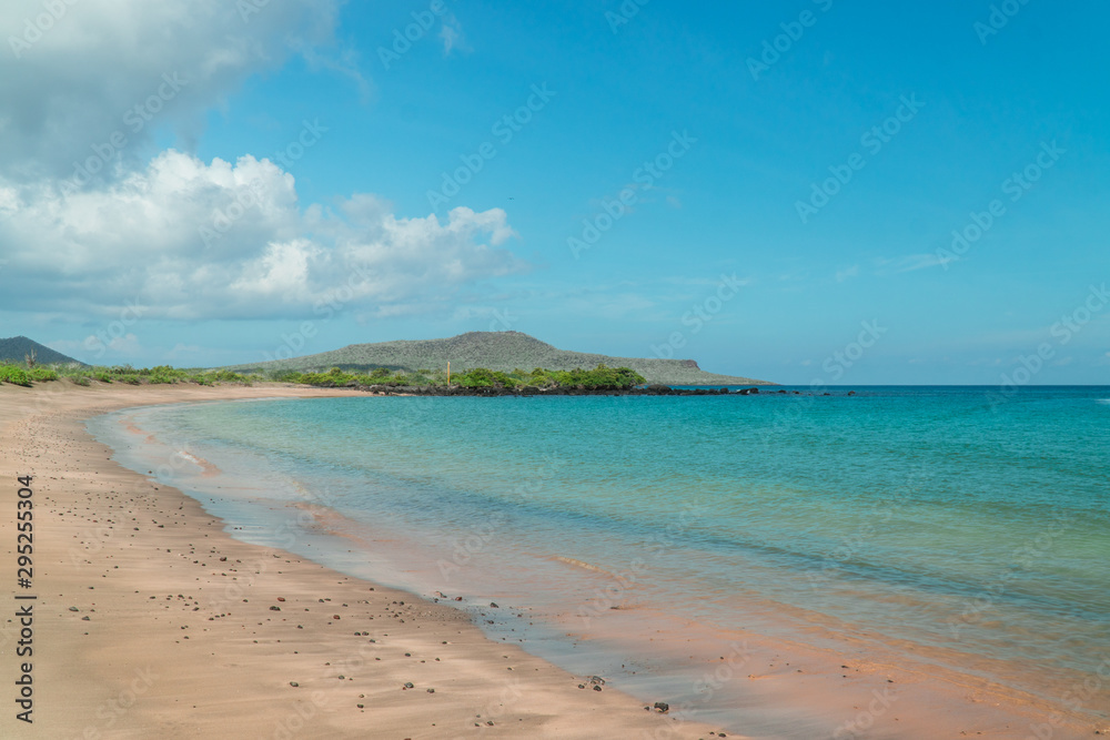 Tropical beach with turquoise ocean waves and white sand. Sand bay view with leading lines. Holiday, vacation, paradise, summer vibes. Shot in Isabela, San Cristobal, Galapagos Islands.Tropical beach 