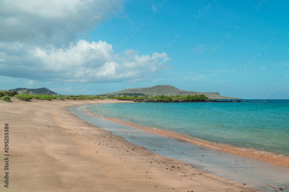 Tropical beach with turquoise ocean waves and white sand. Sand bay view with leading lines. Holiday, vacation, paradise, summer vibes. Shot in Isabela, San Cristobal, Galapagos Islands.Tropical beach 