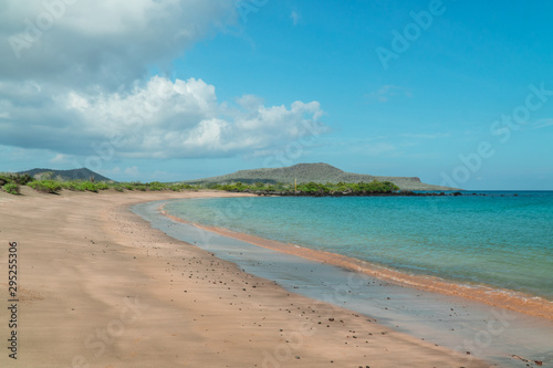 Tropical beach with turquoise ocean waves and white sand. Sand bay view with leading lines. Holiday  vacation  paradise  summer vibes. Shot in Isabela  San Cristobal  Galapagos Islands.Tropical beach 