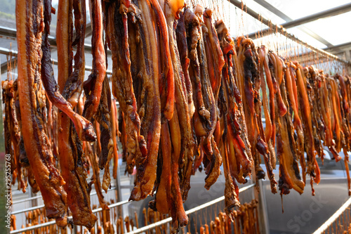 air-dried bacon hanging on shelf and being dried