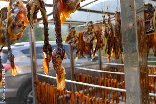air-dried bacon and duck hanging on shelf and being dried