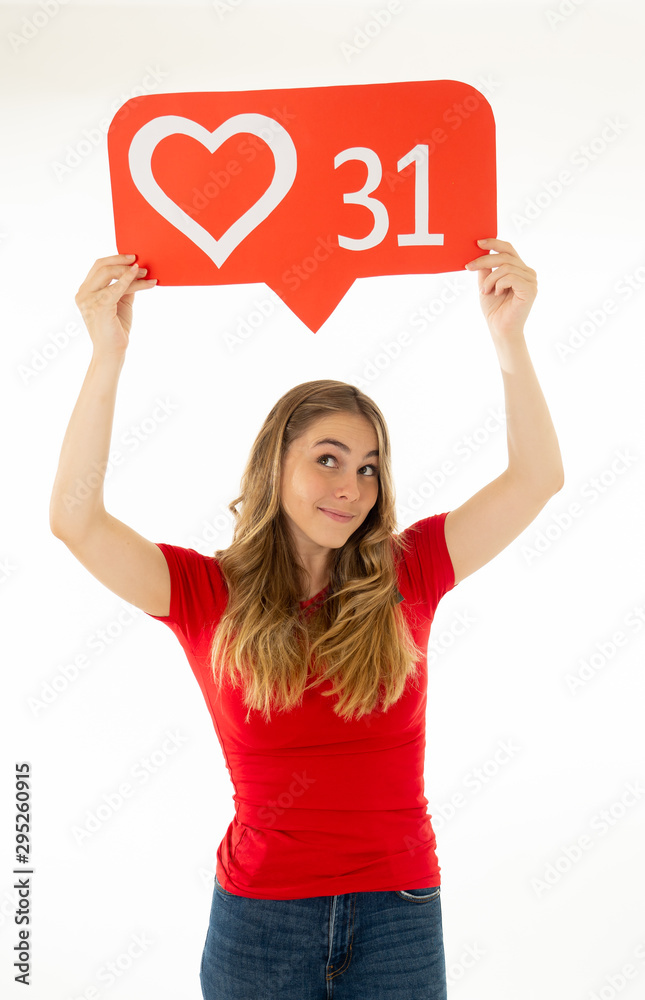 Young woman holding heart social media icon happy. Like and Love social network notifications Young woman holding heart social media icon happy. Like and Love social network notifications