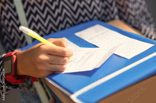 Close up of girl writing the address before sending parcel photo