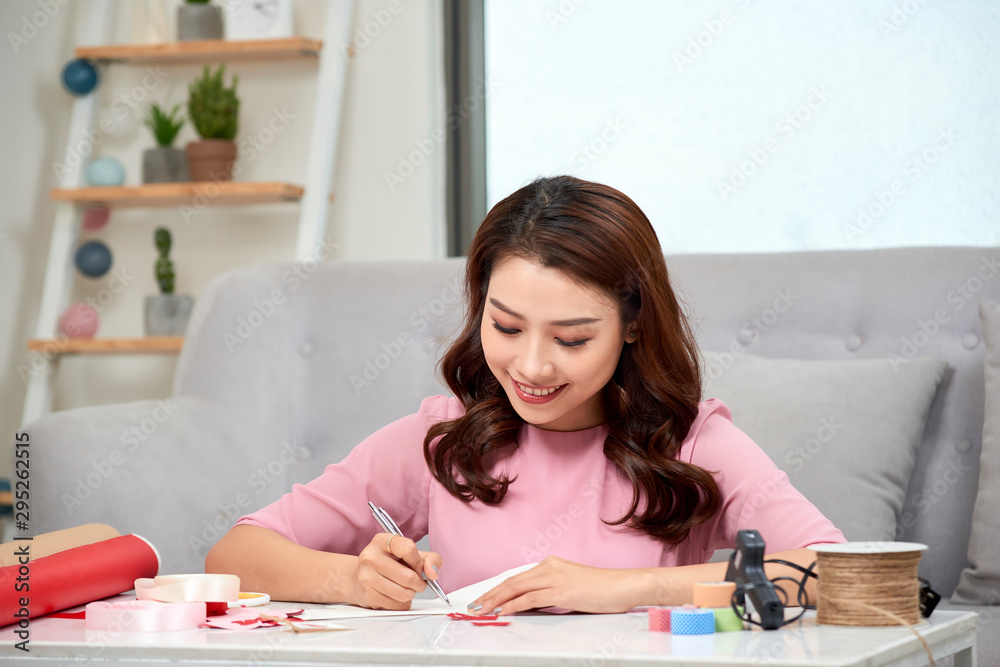 attractive middle aged woman scrapbooking at home attractive middle aged woman scrapbooking at home