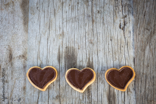 Chocolate heart on wooden background for gift in Valentine's day love. Select focus and Copy space background