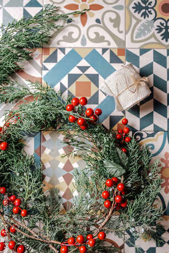 Christmas wreath of evergreen and nandian network berries on retro tiles photo