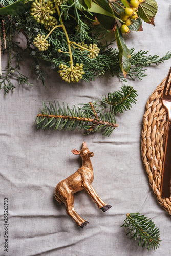 Gold reindeer decoration in the holiday table setting photo