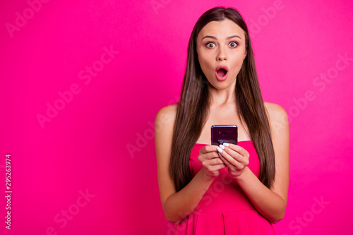 Close-up portrait of nice attractive lovely charming worried stunned long-haired girl using cell expressing astonishment isolated on bright vivid shine vibrant pink fuchsia color background