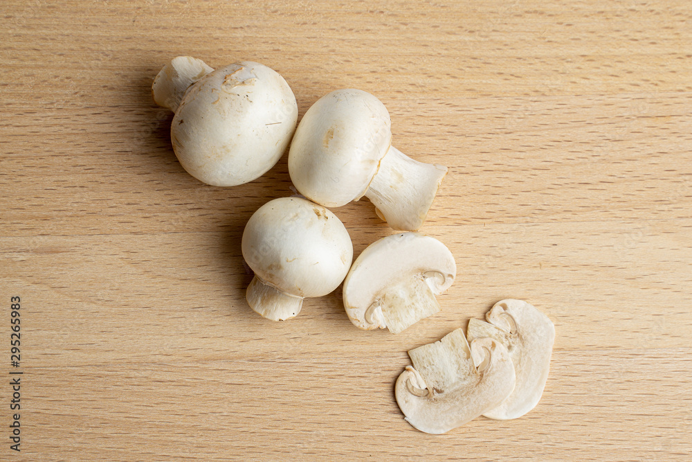 Fresh champignon mushrooms on wood Fresh champignon mushrooms on wood