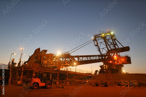 Beautiful landscape sunrise at reclaimer wheel bucket at early morning construction mine site Pilbara region Perth, Australia    photo