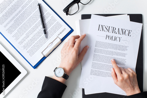 Business woman examining insurance policy photo