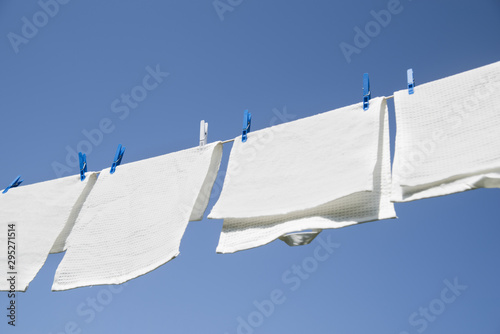 White laundry hanging on a string outdoors