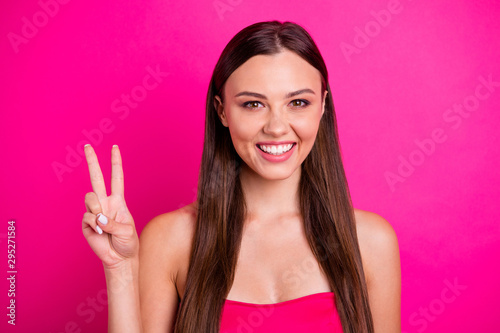 Closeup photo of pretty lady charming smiling showing v-sign symbol saying hello to friends wear bright off-shoulders top isolated vivid pink color background