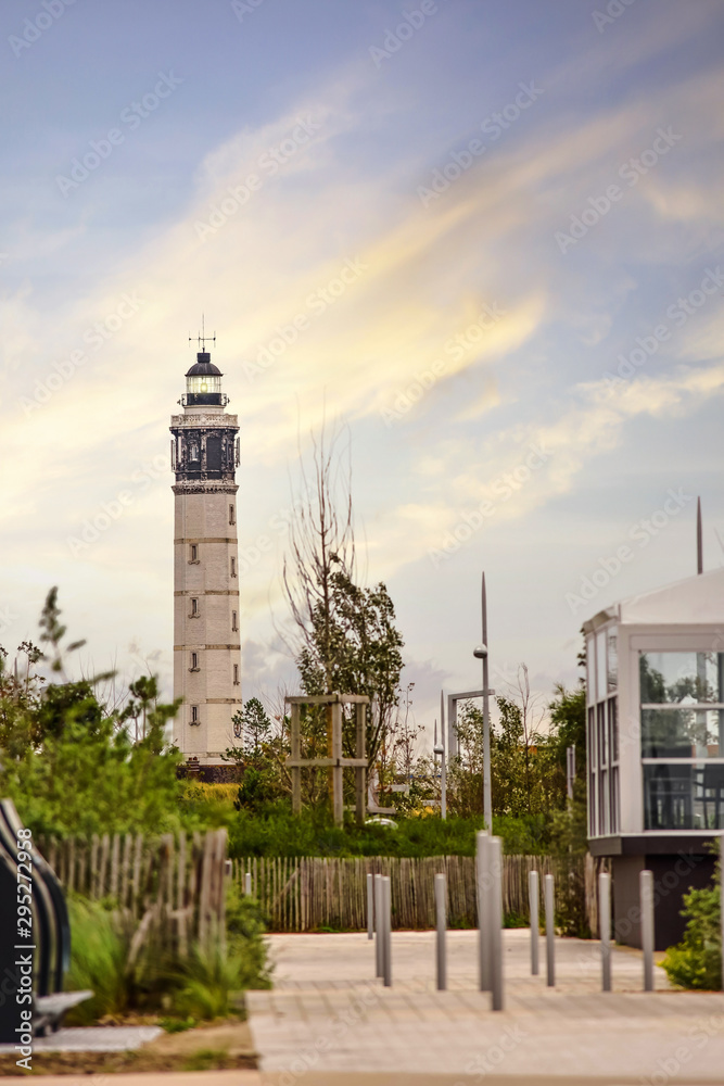 Lighthouse of the city of Calais in France overtaking roofs