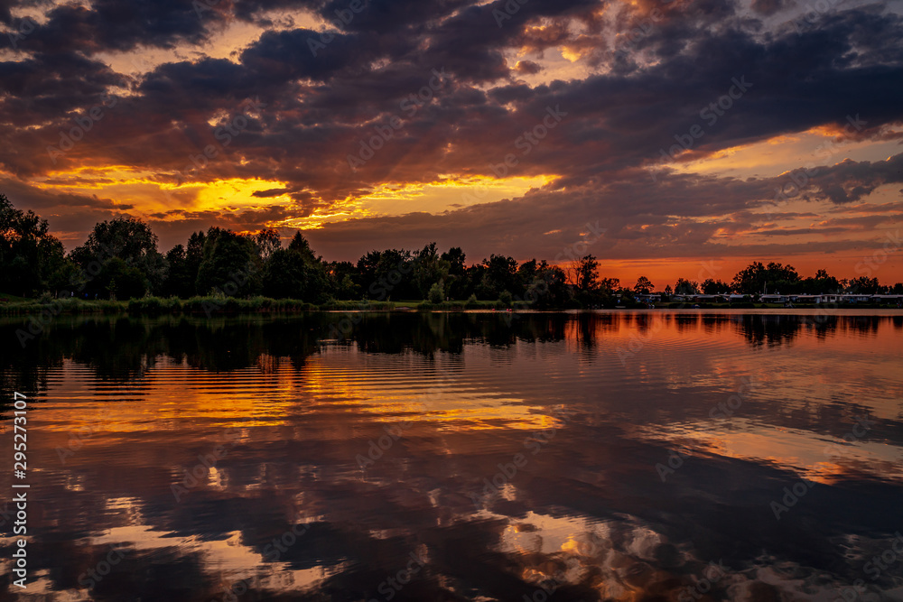 Deep cloudy sunset over the lake