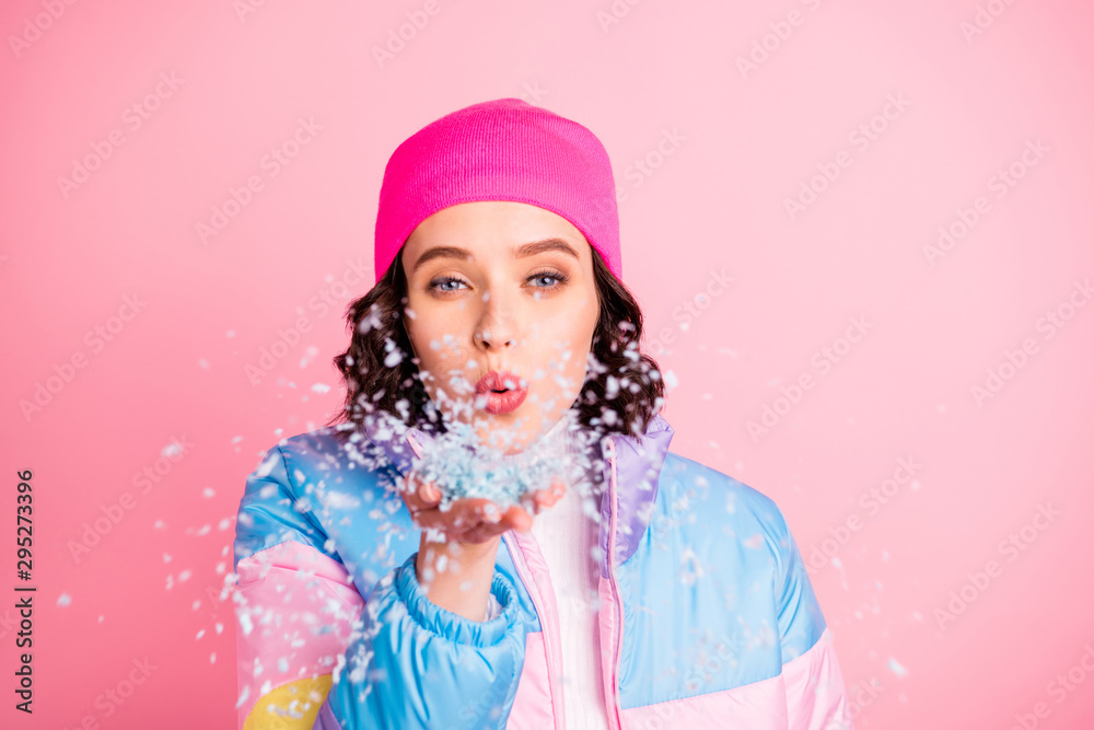 Close-up portrait of her she nice attractive lovely cheerful cheery funny girl having fun enjoying blowing snow weekend holiday isolated over pink pastel background Close-up portrait of her she nice attractive lovely cheerful cheery funny girl having fun enjoying blowing snow weekend holiday isolated over pink pastel background
