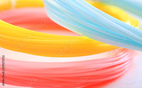 ABS plastic (yellow, blue, pink) on a whte background.