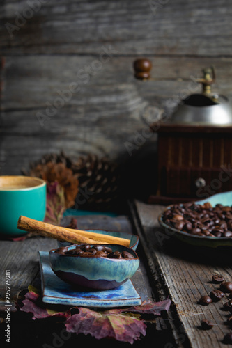 still life,photography coffee table coffee beans in plates and cup, wooden background,coffee grinder, food and drink