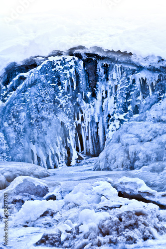 Snow covered icy waterfall for postcard