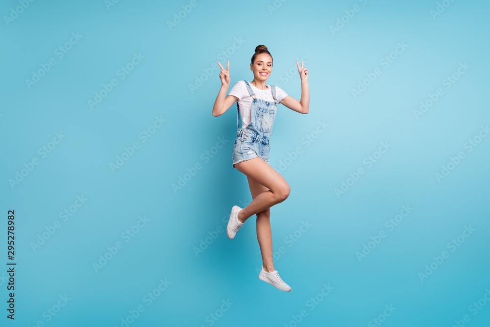 Full length body size photo of charming nice girl showing you v-sign while isolated with blue background