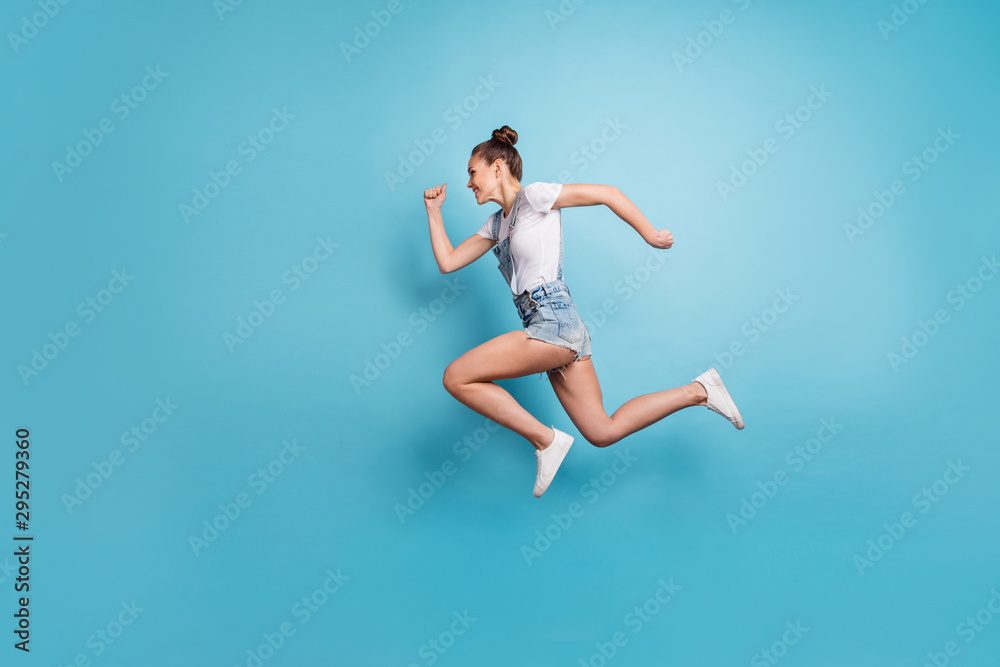 Full length body size photo of girlfriend running as quick as she can while isolated with blue background Full length body size photo of girlfriend running as quick as she can while isolated with blue background