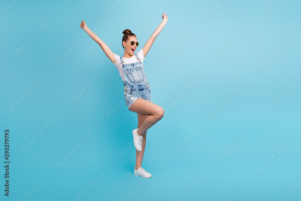 Full length body size photo of rejoicing overjoyed girl dancing wearing sunglass having fun vacation while isolated with blue background