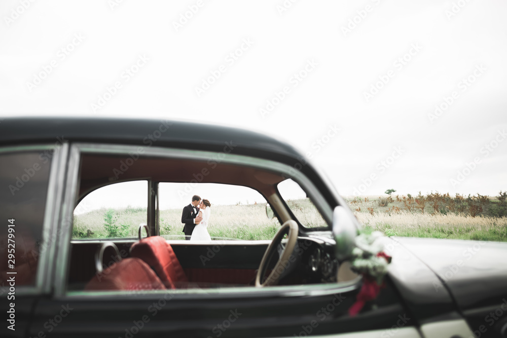 Just married couple in the luxury retro car on their wedding day Just married couple in the luxury retro car on their wedding day