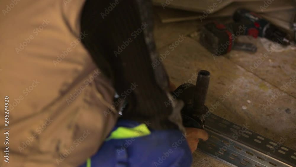 Worker Using Angle Grinder Cutting Tool. Sparks Close Up Worker Using Angle Grinder Cutting Tool. Sparks Close Up