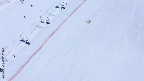Aerial view of ski slope - ski lift, skiers and snowboarders going down