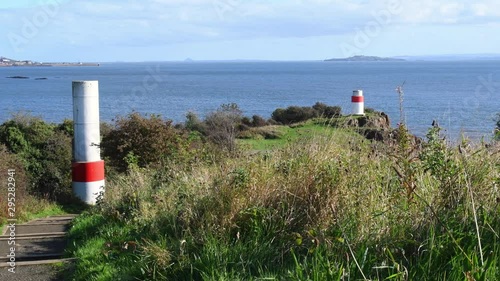 Video of the Firth of Forth estuary and two lighthouses in Aberdour, Fife. Lighthouse near Silversands Bay. Aberdour is a scenic and historic village on the south coast of Scotland. photo