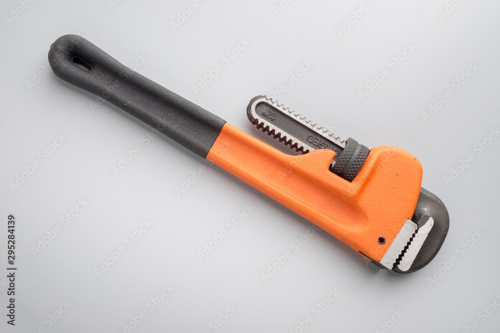 Pipe wrench on grey background