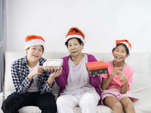 Asian children give present to their grandmother, lifestyle concept.